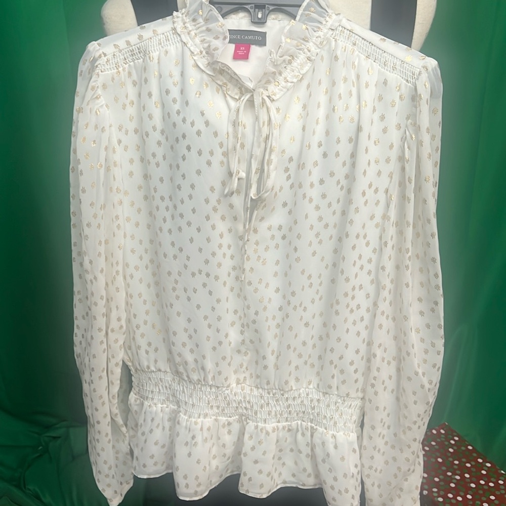 Vince Camino peplum top. White a gold in color.